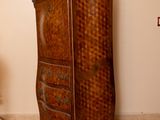 a tall wooden cabinet in a room with a checkered floor