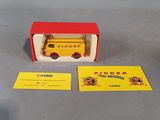 a small yellow toy truck in a red and yellow box