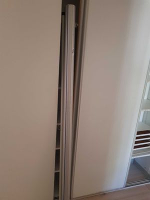 a refrigerator with a door open in the corner of a room