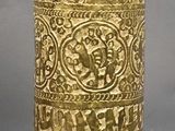 a gold vase that is sitting on a table