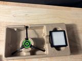 a wooden table with a clock and a cell phone on it