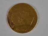 a gold coin with a picture of a man on it
