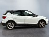 the white suv is parked in a room with a gray floor