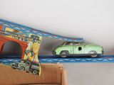 two toy cars that are sitting on top of a cardboard box