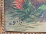 an oil painting of flowers in a gold frame on a table