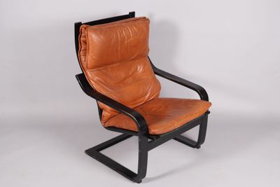 a brown leather chair with a black frame and black legs