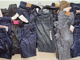 many different types of jeans on display in a store