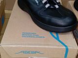 two pairs of shoes that are on top of a box