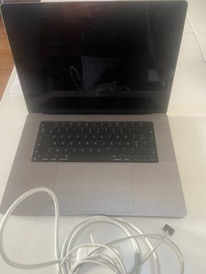 un ordinateur portable posé sur une table, avec son chargeur