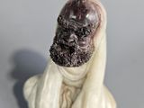a figurine of a man with a beard sitting on a table