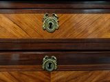 a marble top on a wooden chest of drawers