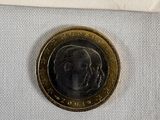 a close up of a coin with a barcode on it