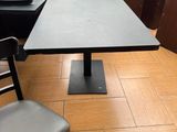 a black table and a black chair in a room
