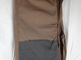 a bag hanging on a wall with a wooden hanger