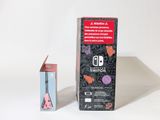 a box of nintendo switch next to a box of nintendo wii controllers