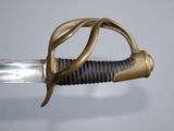 a close up of a sword with a gold handle