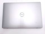 dell laptop computer sitting on a white surface with a dell logo on the screen