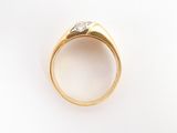 a close up of a gold ring with a diamond in the center
