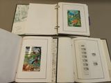 several open books on a table with pictures of animals on them