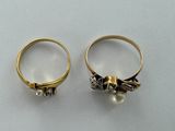 two gold rings with pearls on them sitting next to each other