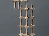 an image of a metal sculpture on top of a white pedestal