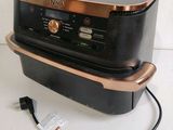 an image of a black and copper microwave oven