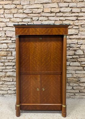 an old wooden cabinet with two doors and a drawer underneath it