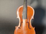 an old violin sitting on top of a wooden stand