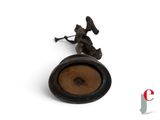 a statue of a man holding a trumpet on top of a table