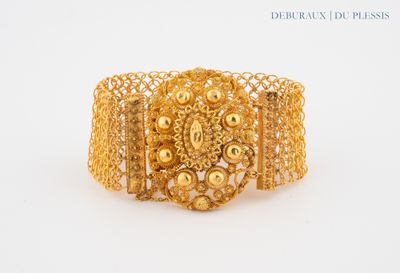 an image of a gold bracelet on a white background
