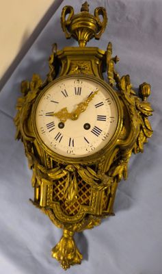 a gold clock on a white sheet with a blue background