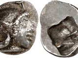 a close up of a coin with a face on it