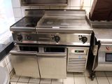 a kitchen with a stove, oven, and sink in it