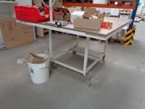 an image of a workbench in a warehouse with boxes on the floor