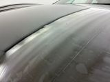a close up of the hood of a silver car