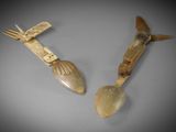 pair of carved wooden spoons with handles and spoon rest
