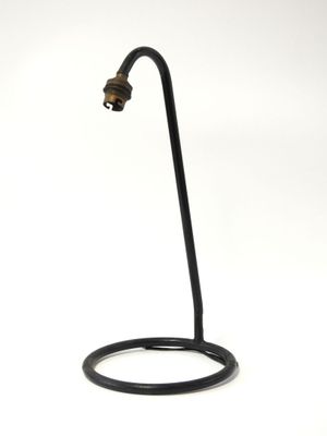 a lamp that is on a stand on a white surface