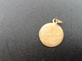 an image of a close up of a gold medal on a black surface