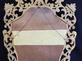 an old wooden mirror with a white stripe on it