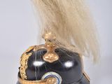 a black helmet with a gold decoration on top of it