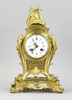 a gold clock that is sitting on a table