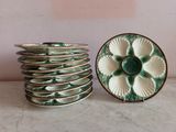 a stack of green and white plates sitting on a table