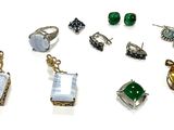 many different types of jewelry displayed on a white surface