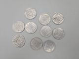 six different types of silver coins on a white surface