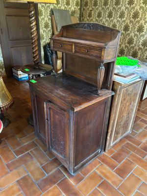 a wooden desk with a drawer on top of it in a room