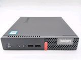 a close up of a small black computer on a white surface