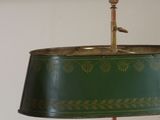 a green lamp that is on a table in front of a mirror