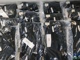 a lot of black pants that are wrapped in plastic