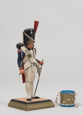 figurine of a toy soldier with a drum and a drum