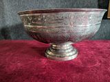 a silver bowl sitting on a red table cloth